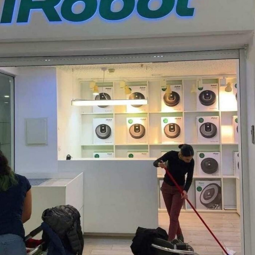 girl-shes-wiping-the-floor-in-a-store-that-sells-iRobot-cleaning-robots-1024x1024